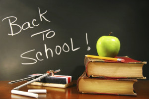 School books with apple on desk