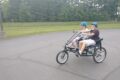 JESSICA SWAN PHOTO The Independent-Register
	Brodhead students Jesse Douglas and Jayden Hanson enjoy some time outside pedaling the new side-by-side tricycle that’s specially adapted for students with special needs.  Grant money was used to purchase two tricycles.