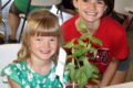 PHOTO SUBMITTED The Independent-Register
	Spring Grove Honest Workers 4-H club members Ellie Makos and Reaghan Schmelzer share a smile together during Cloverbud judging during the Green County Fair.