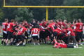 The Cardinals players and coach Matthys celebrate after the Cardinals earned their 6th straight victory on the season