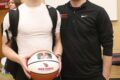 Cardinals coach Tommy Meier presents Cullen Walker with a commemorative basketball to honor his 1,000th career point on Friday, Feb. 2.